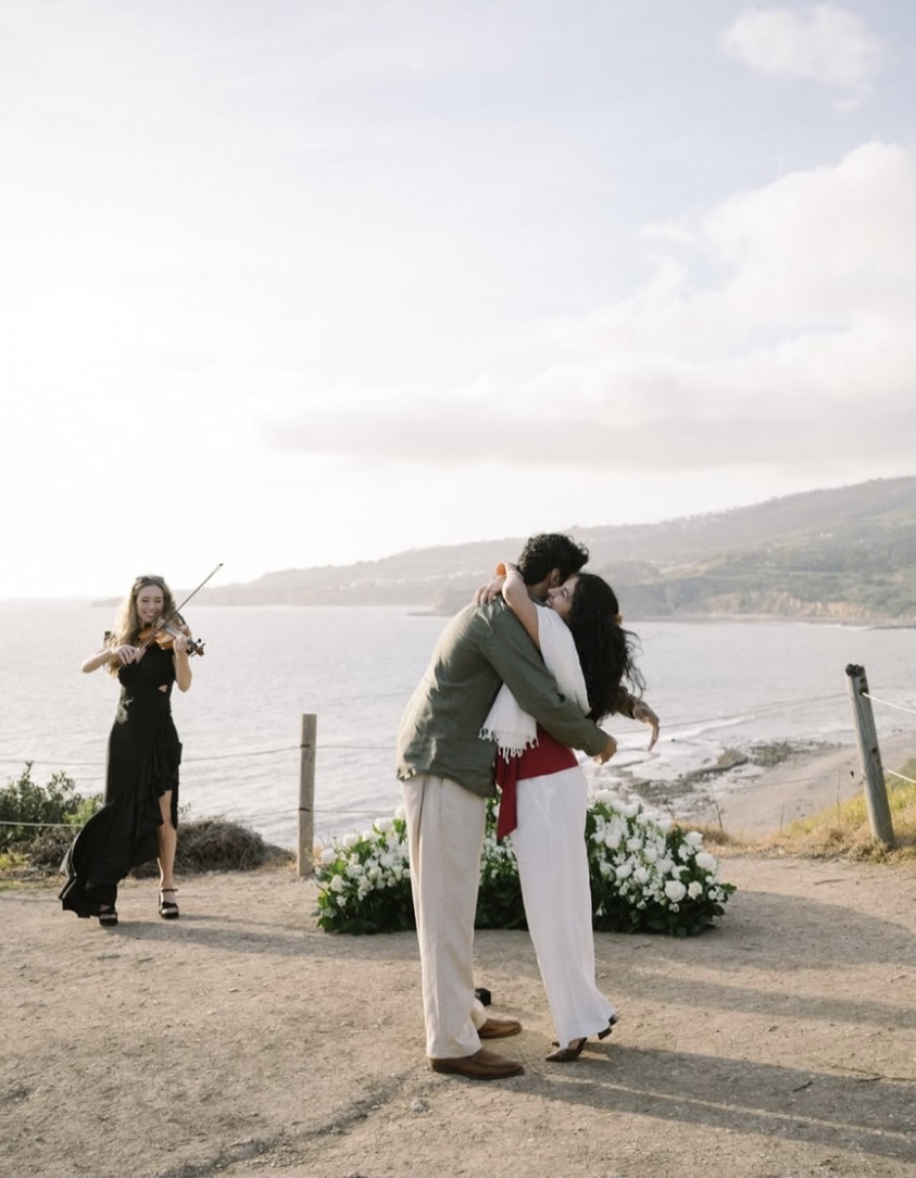 Elin Wolf performing violin during an oceanfront proposal